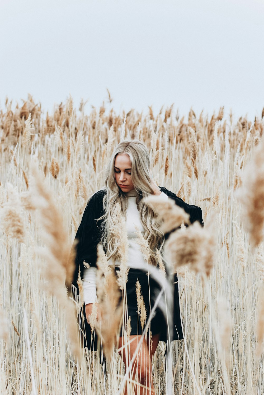 woman standing in wheat covered area