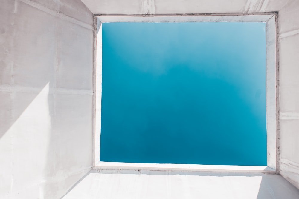 um céu azul visto através de uma janela em um edifício