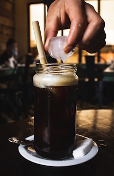 Clear ice tubes being loaded into a delivery van for café orders in Semarang