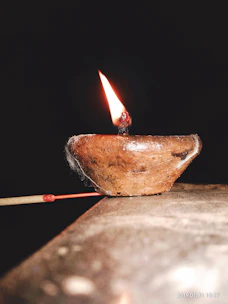 Close-up of a glowing temple lamp burning steadily with Shree Aradhana Pooja Oil.