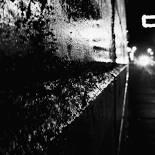 Close-up of a smooth, glossy wall surface treated with Aqua-Shield, reflecting light under industrial lighting.