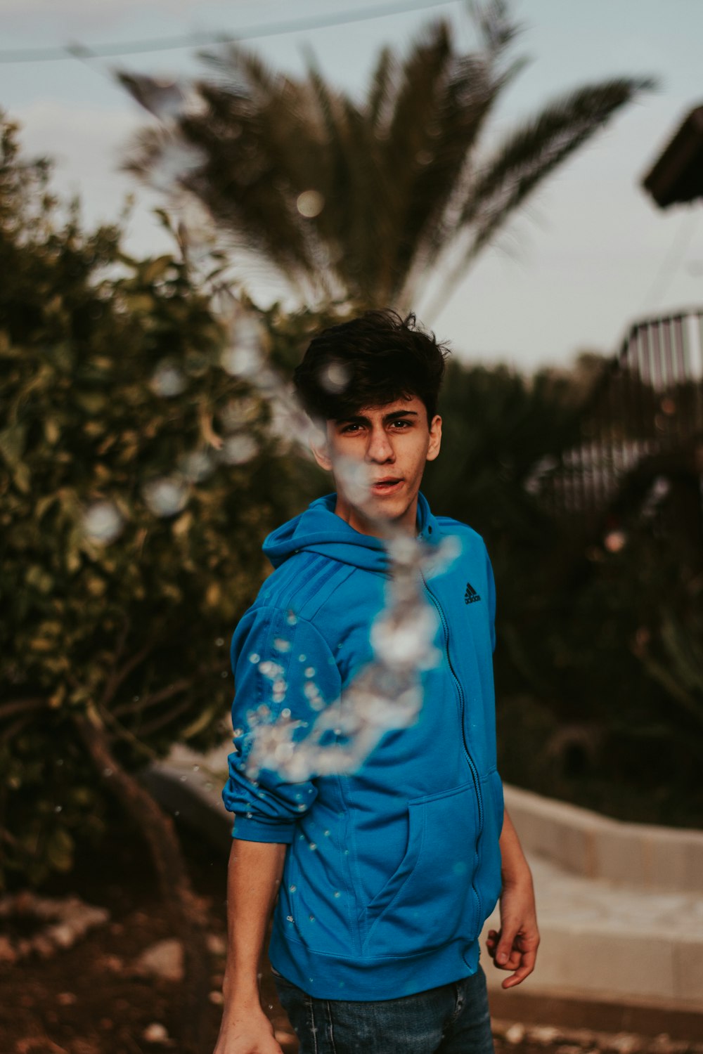 man wearing blue sweater standing