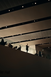 Interior designers arranging modern furniture and lighting in a corporate space.