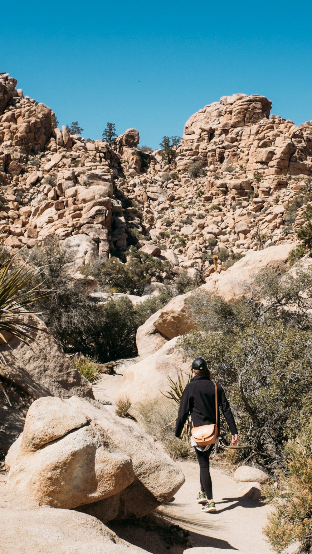 woman walking near rock formation during daytime