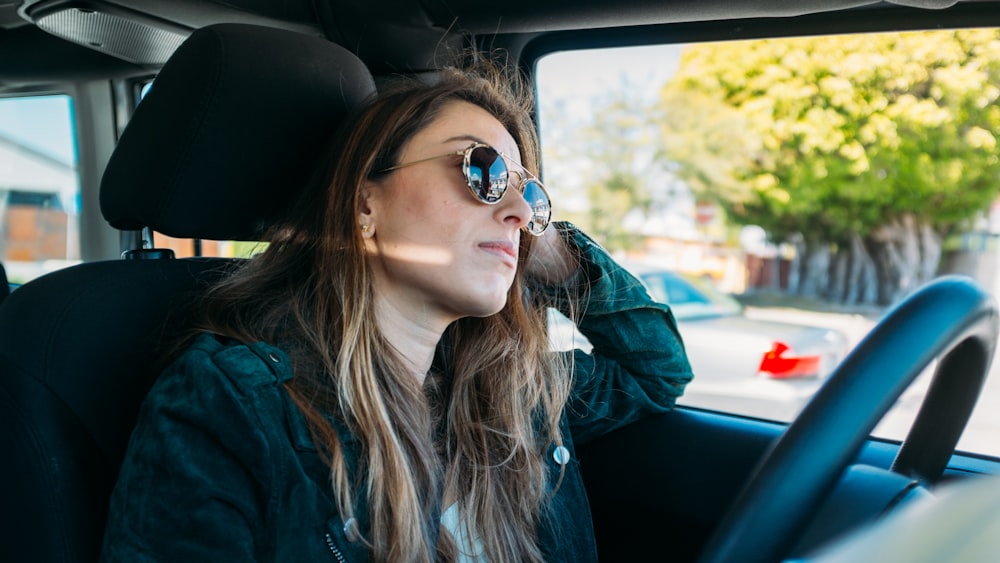 woman sitting inside vehicle during daytime