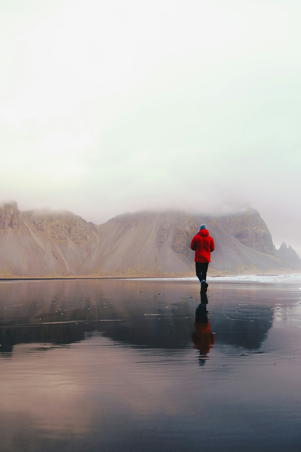 person walking on seashore