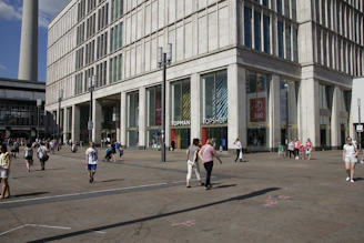 A modern commercial building with 'For Rent' signage in a busy area.