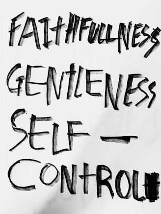 The image features bold, hand-painted words in black on a white background. The words 'Faithfulness', 'Gentleness', and 'Self-Control' are prominently displayed in an expressive brushstroke style.