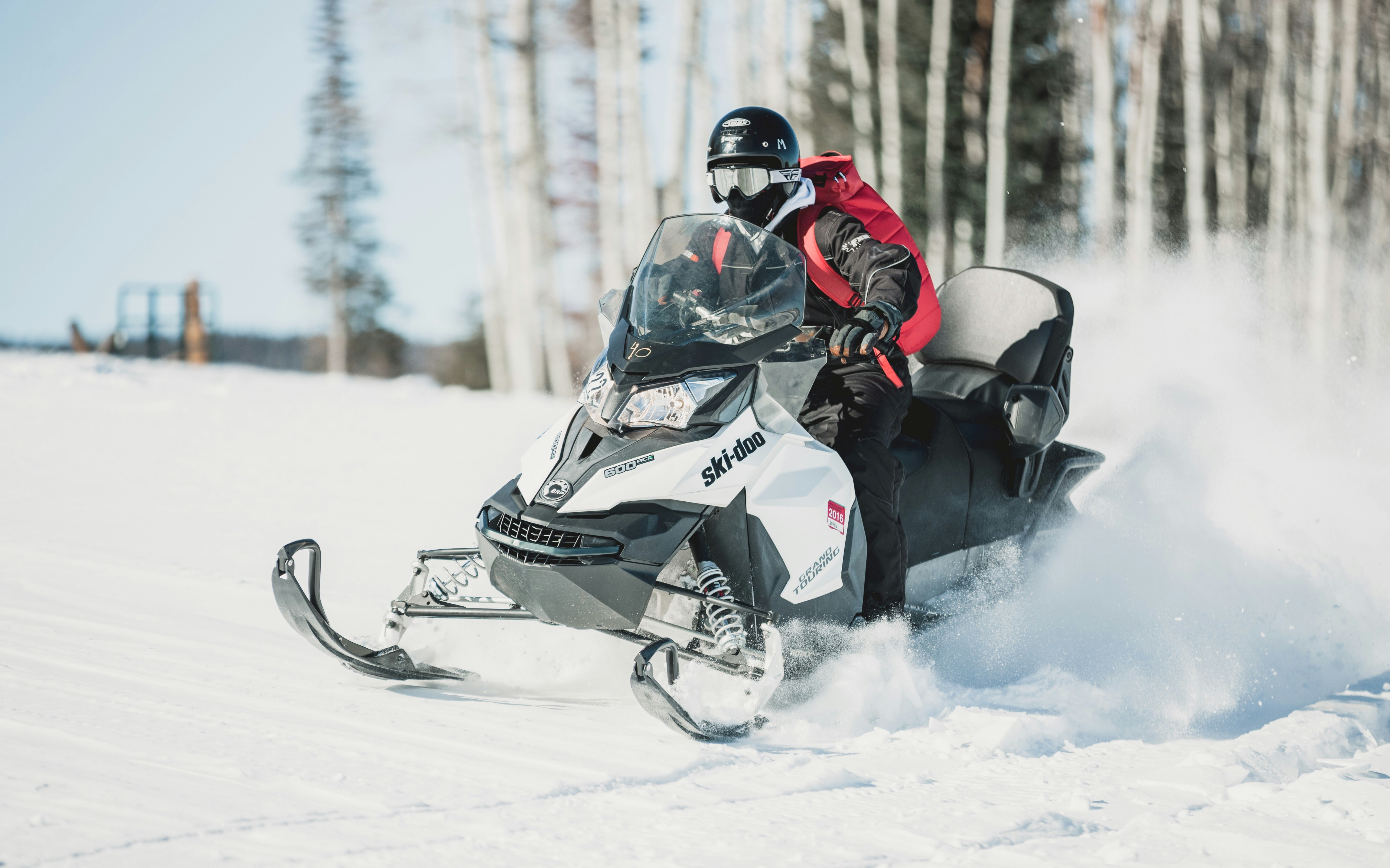 A skidoo snowmobile ripping through the snow in the winter