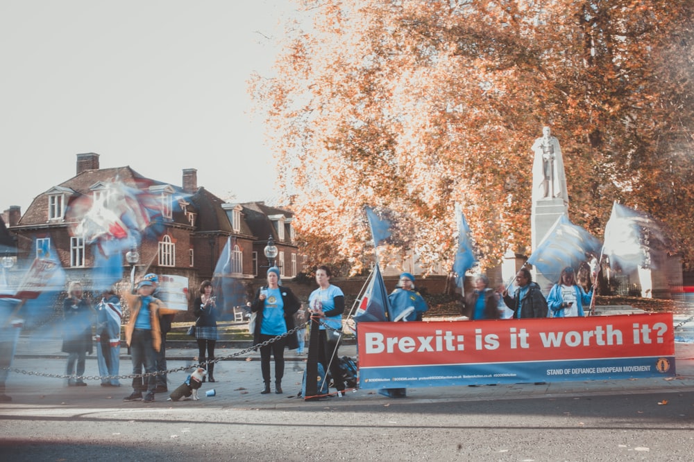 people holding Brexit: is it worth it banner during daytime