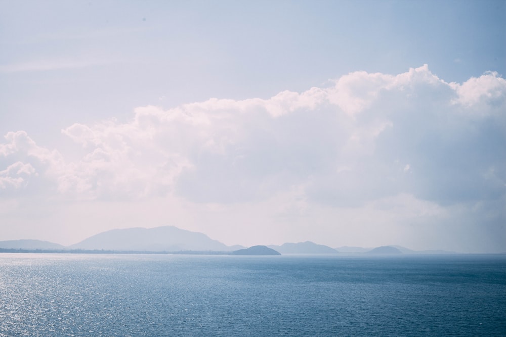 panoramic photography of body of water near mountain range