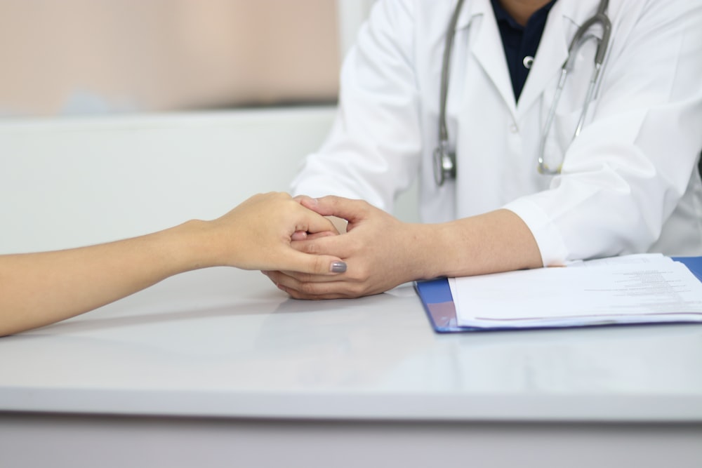 person holding hands with doctor