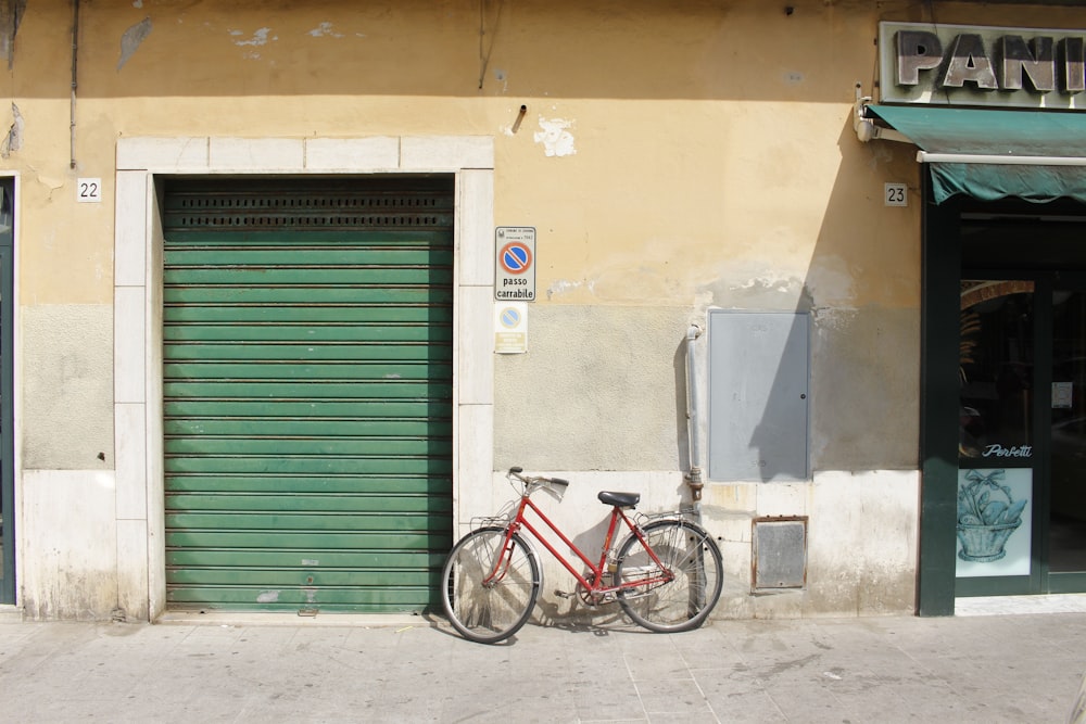 red city bicycle parked by the closed store