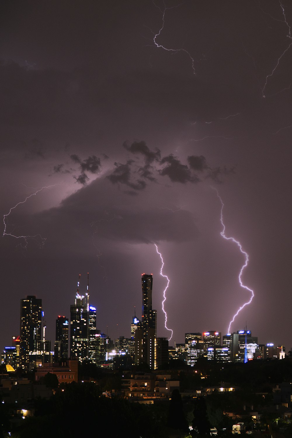 time lapse photography of highrise building under lightning