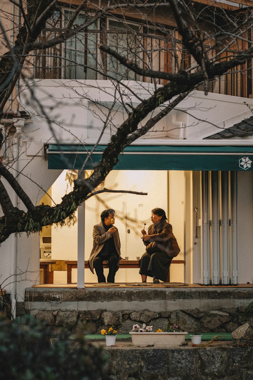 man and woman sitting inside house on focus photography
