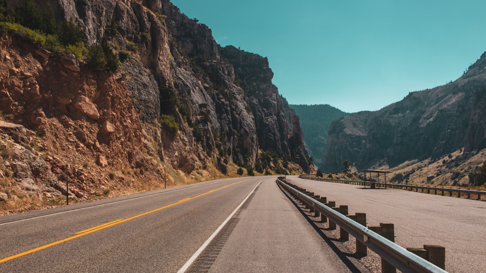 empty road beside rocky mountain