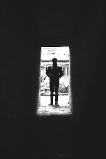 A still from a short film showing a silhouette against a neon-lit alley