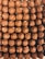 Close-up of glossy chocolate balls arranged neatly on a rustic wooden board.