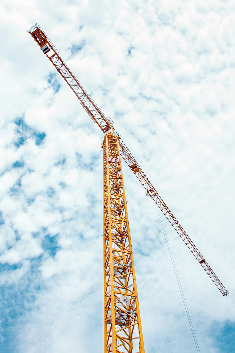 low angle photography of yellow truss crane