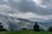 A serene landscape with a person contemplating their future on a hilltop.
