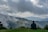 A serene landscape with a person contemplating their future on a hilltop.