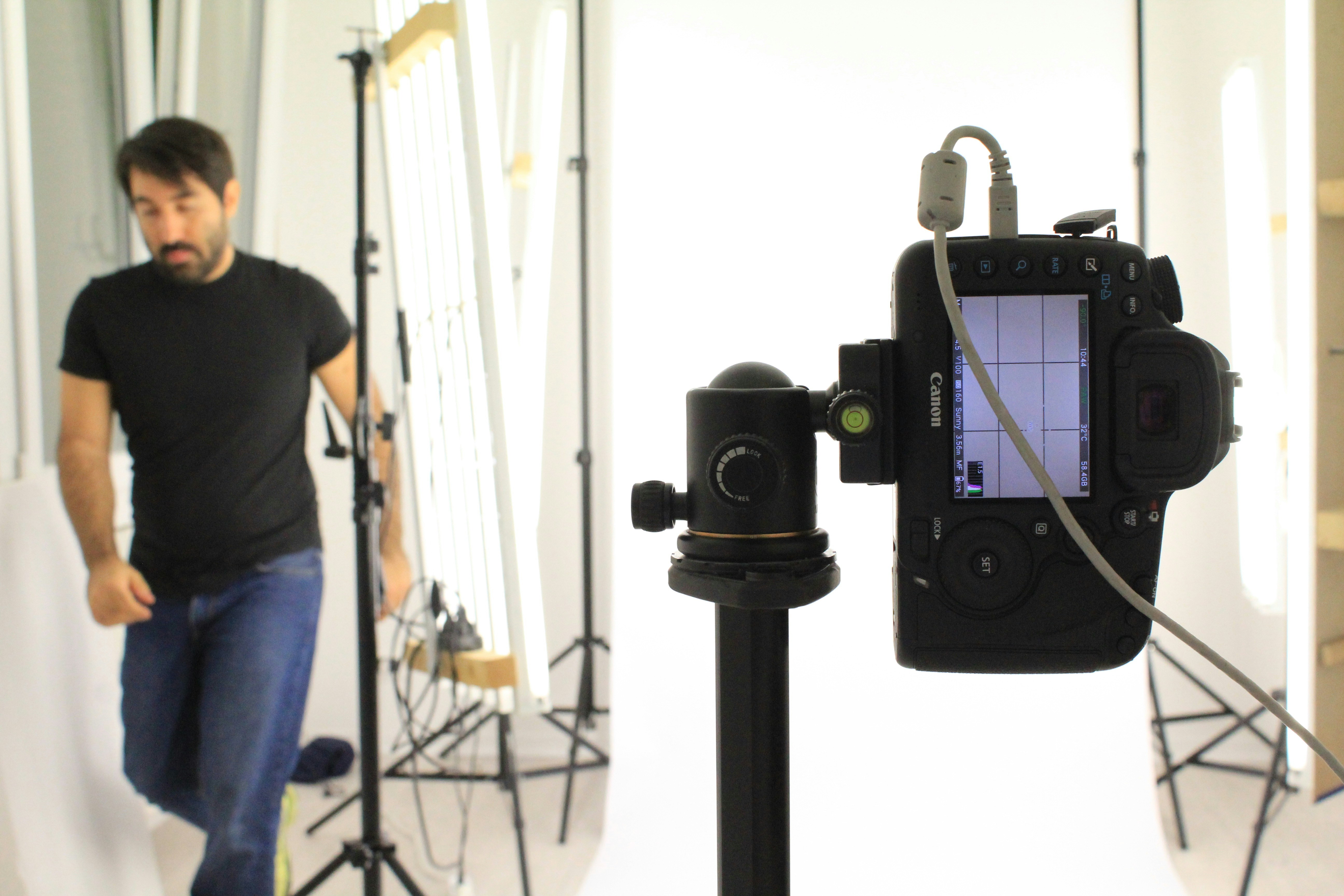 Man in navy polo shirt, clean studio background, natural lighting