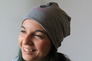 A candid shot of a performer smiling warmly at her webcam in a softly lit room.