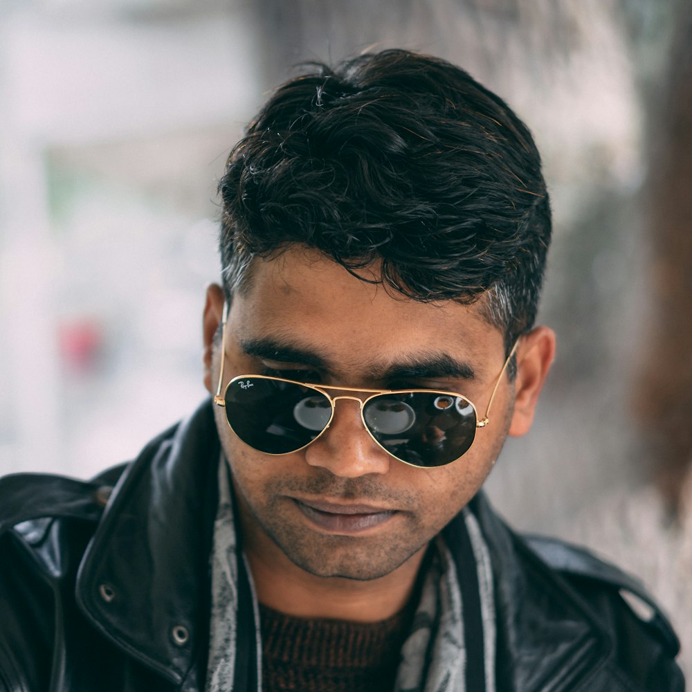 man wearing sunglasses on selective focus photography