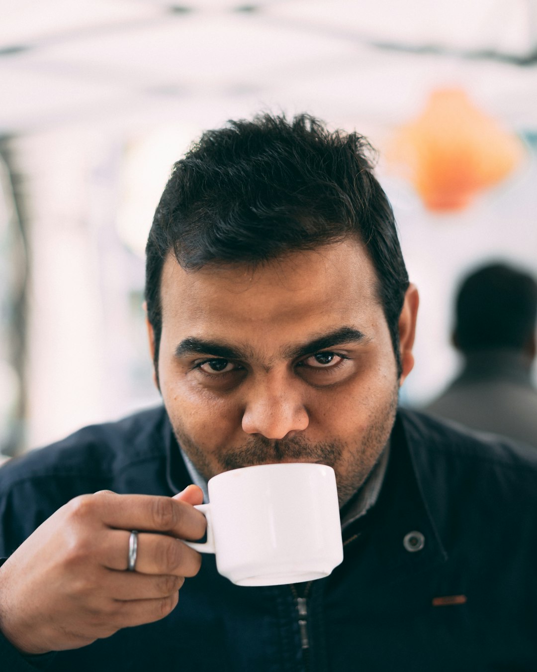 man holding white mug