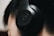 Close-up of a person listening to a sports podcast with headphones.
