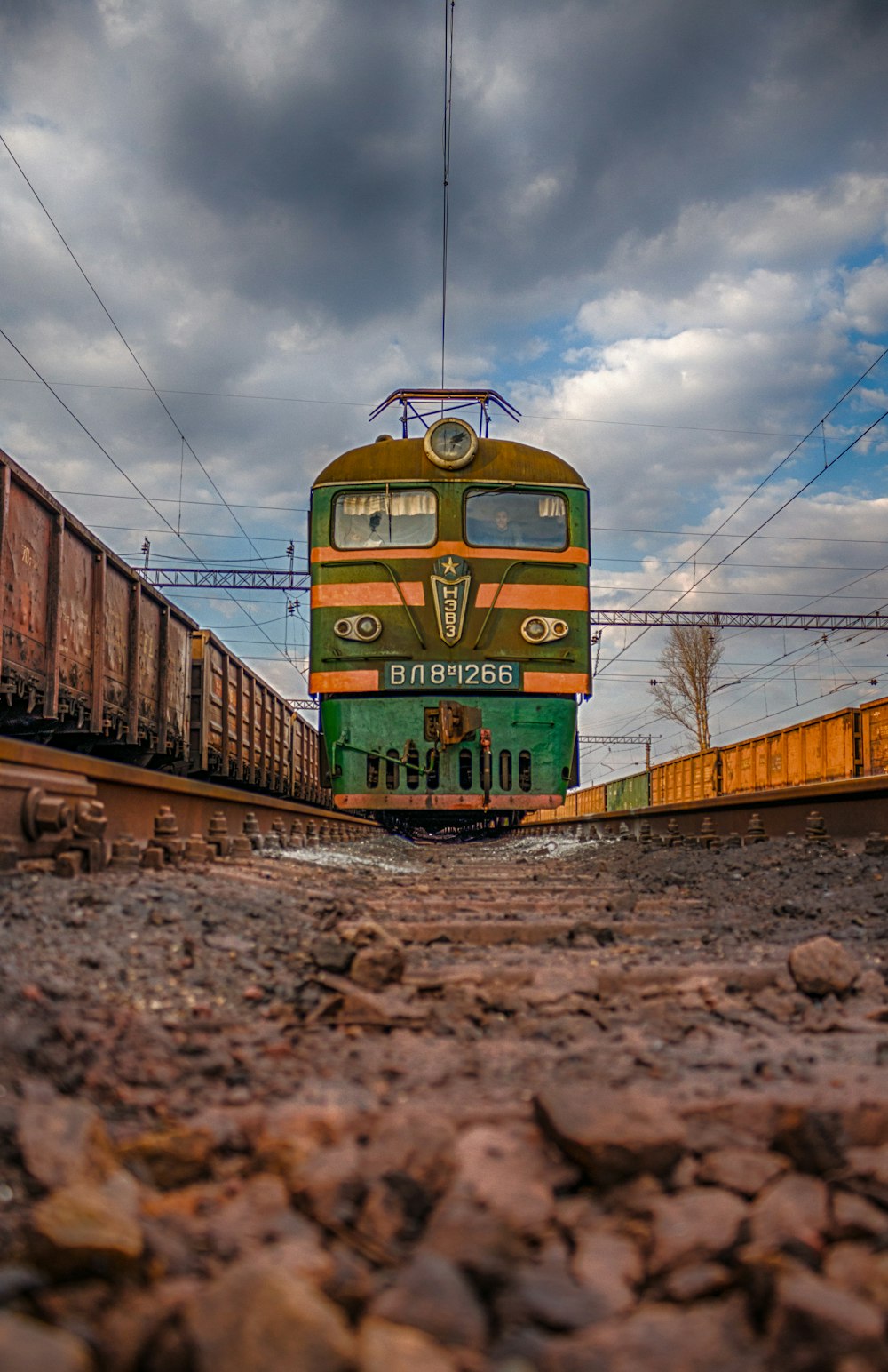 green and yellow train on railway