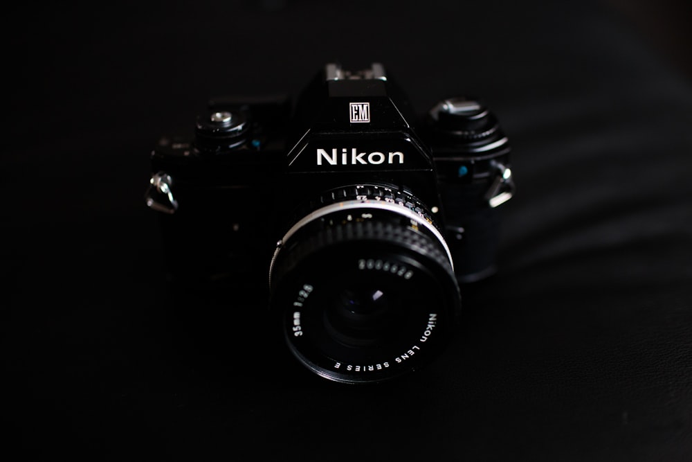 black Nikon bridge camera on gray textile
