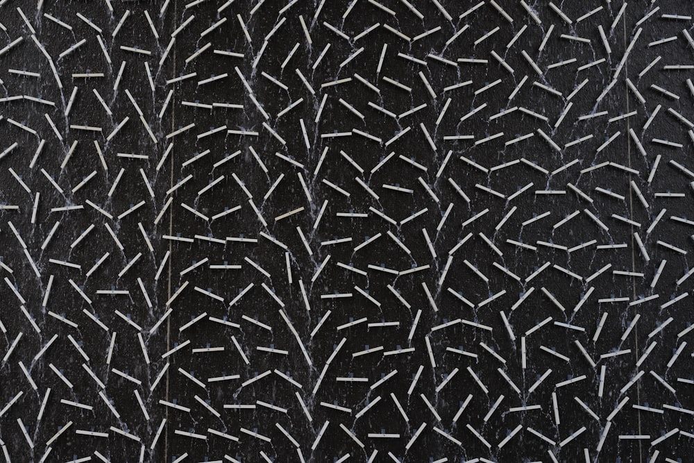 a close up of a black surface with white lines