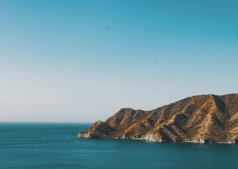 brown mountain facing ocean