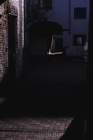 A dimly lit alley showcasing intricate shadows.