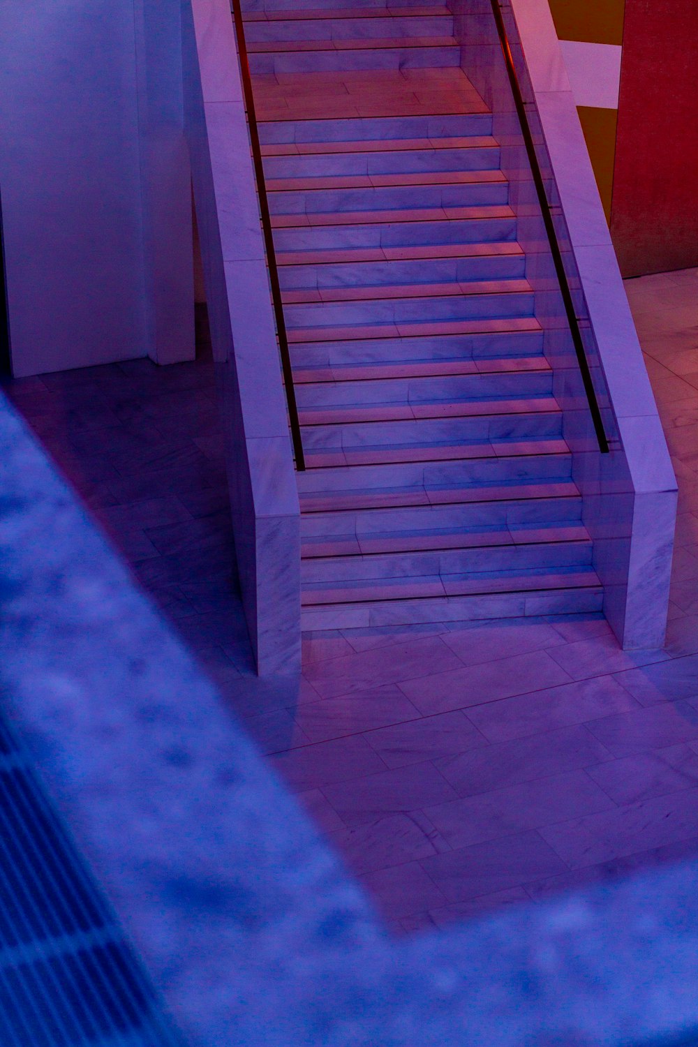 a stair case next to a building with a clock on it