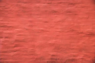 A freshly painted wall in a warm terracotta shade, showcasing the quality of Asian Paints.