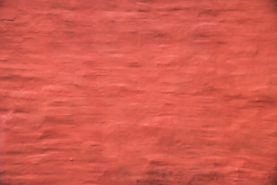 A freshly painted living room wall in rich red with gold accents, showcasing a smooth and professional finish.