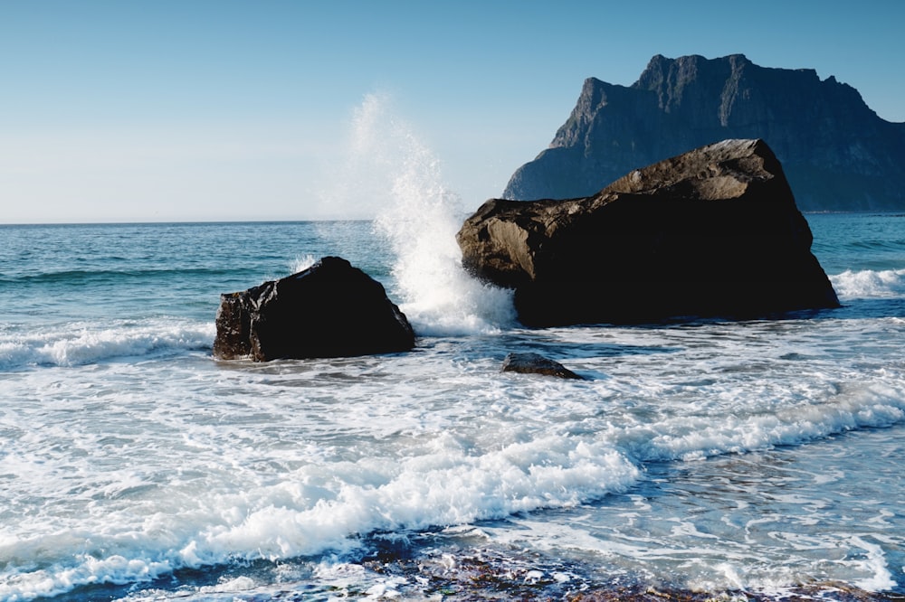 wave of water splashed on rock