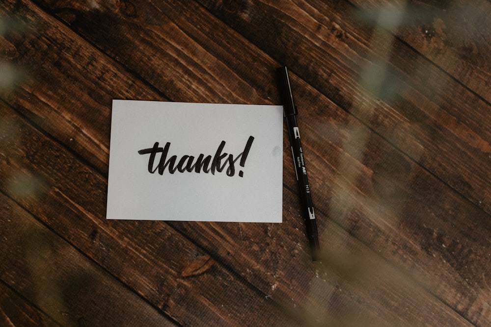 A thank-you card and pen on a table