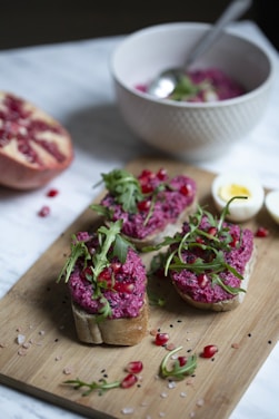 Close-up of a colorful no-cook filling spread on a fresh bread slice with vibrant ingredients around.