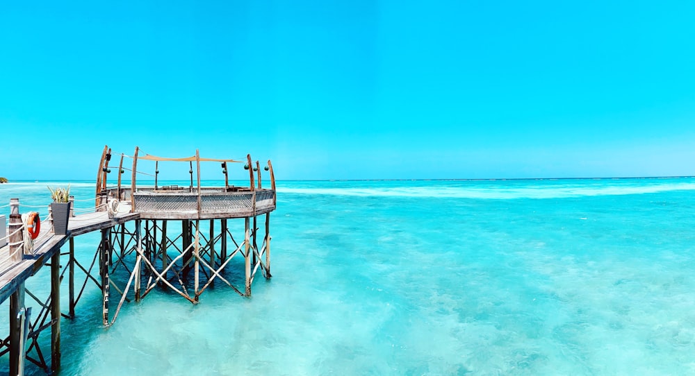 gray wooden dock under clear blue sky