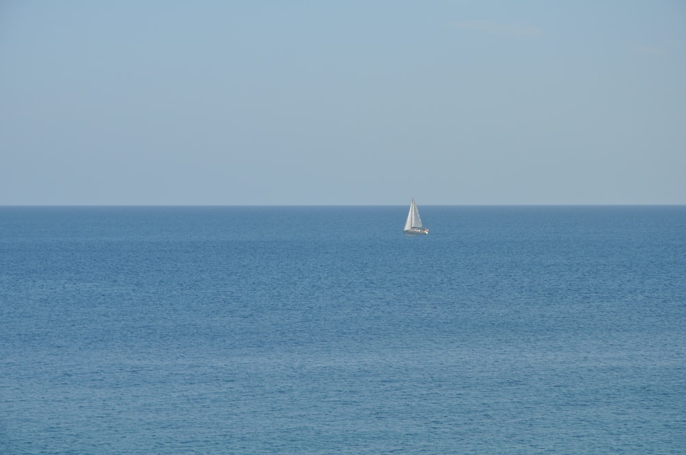 white sailboat on blue calm water