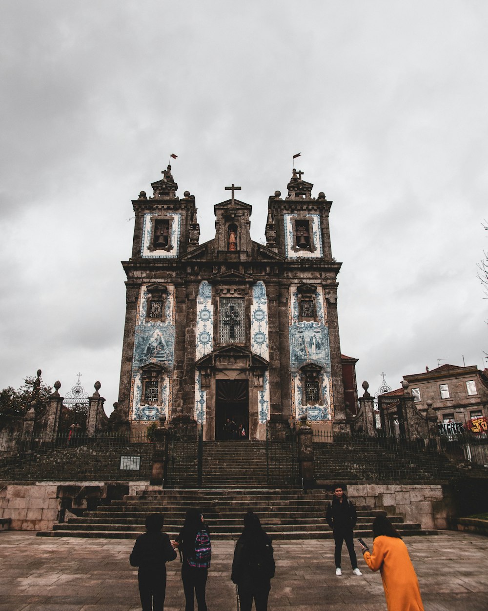 people standing near brown concrete cathedral