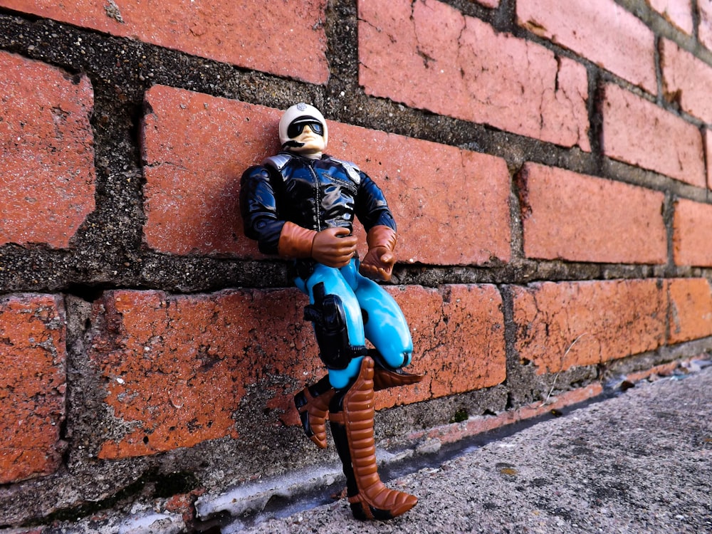 plastic toy leaning on concrete wall