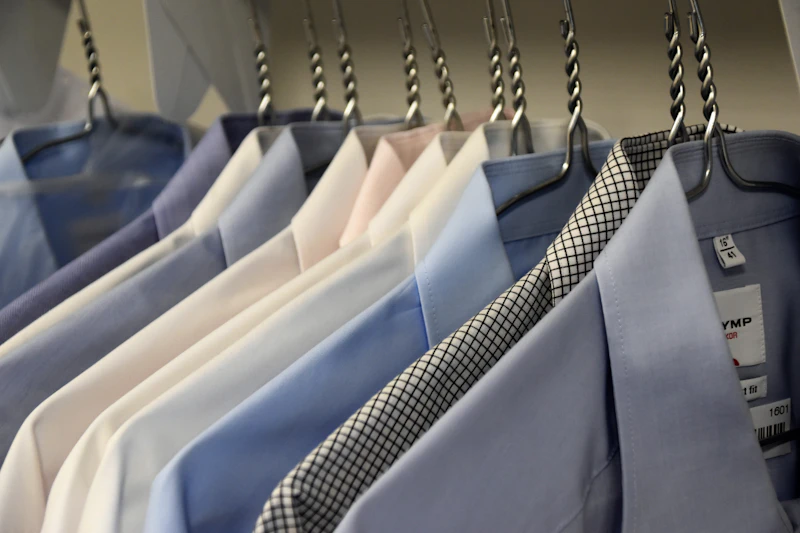 Freshly cleaned dress shirts hanging in a row
