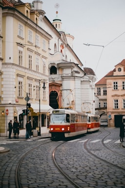 red and white train beside building