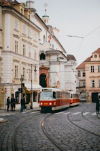 red and white train beside building