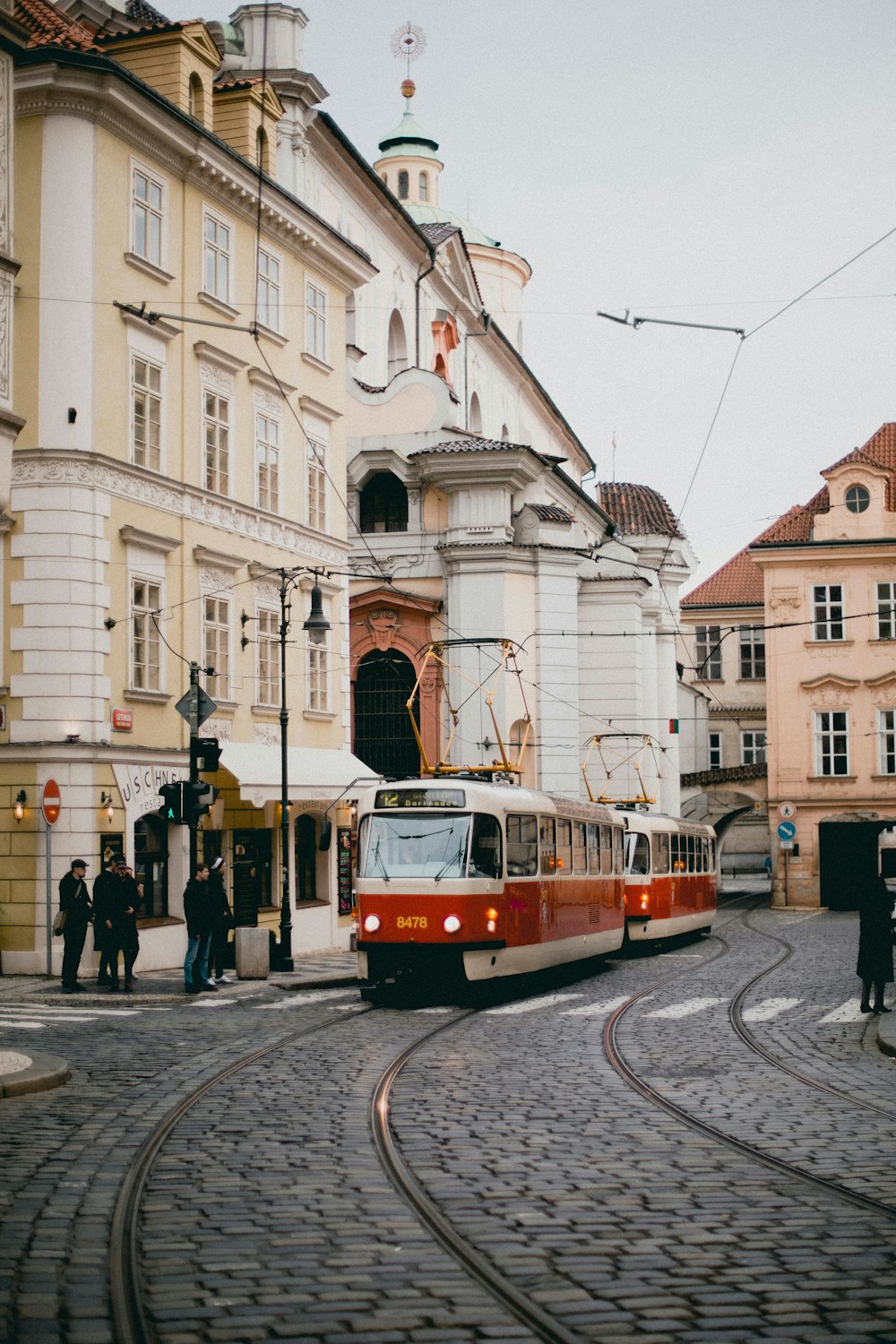 red and white train beside building