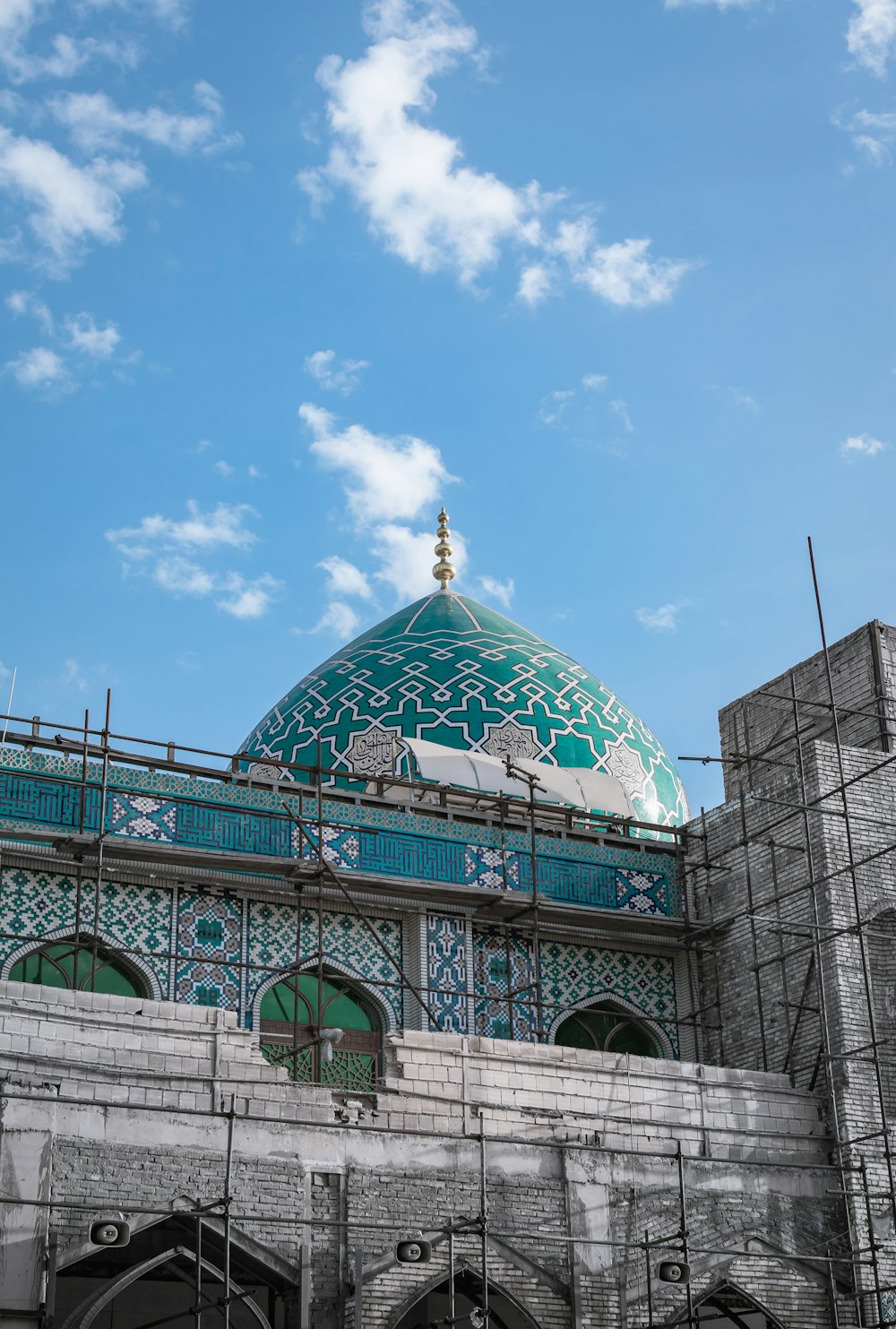 gray and blue building with dome under blue sky